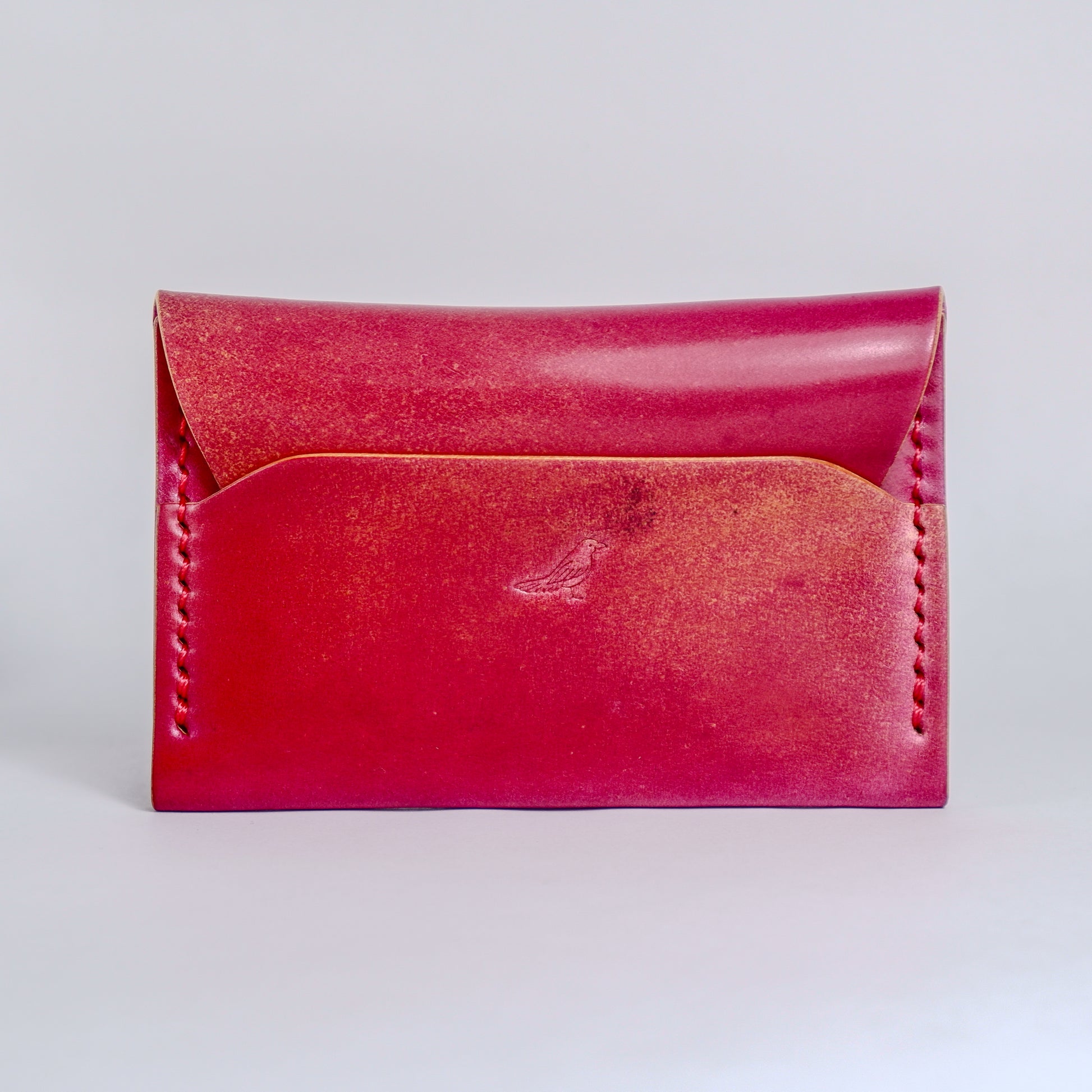 Closed Electric Pink The Warden-Marbled Shell Cordovan Wallet displayed on a white background.