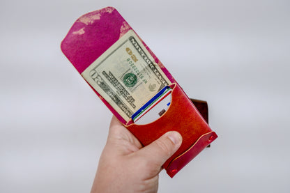 Opened Electric Pink Archer-Marbled Shell Cordovan Wallet displayed on a white background viewed from the front