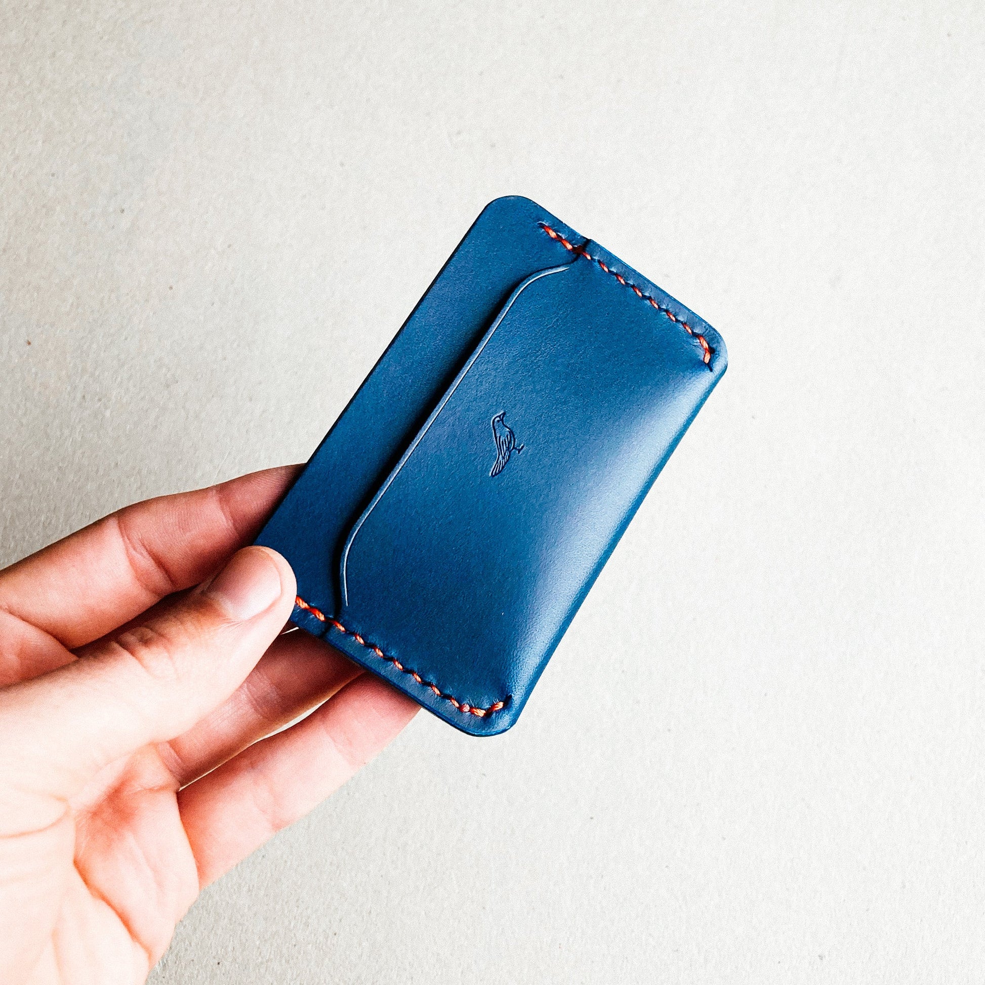 Blue Pattern - Erikson Wallet held by a man against a white blurred background.