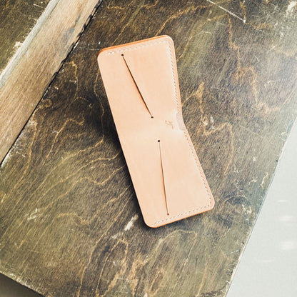 Opened Natural Pattern - Kingston Wallet displayed on a brown table viewed from above.