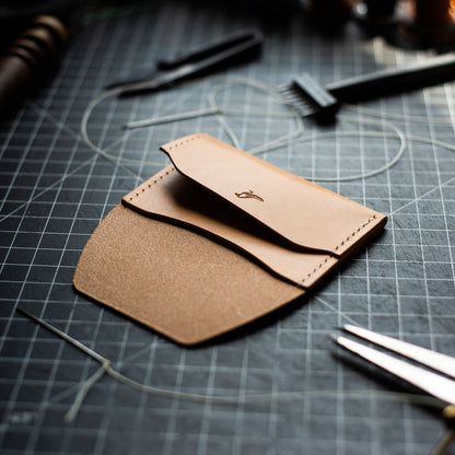 Opened Natural Pattern - Warden Wallet displayed on a workbench with tools nearly.