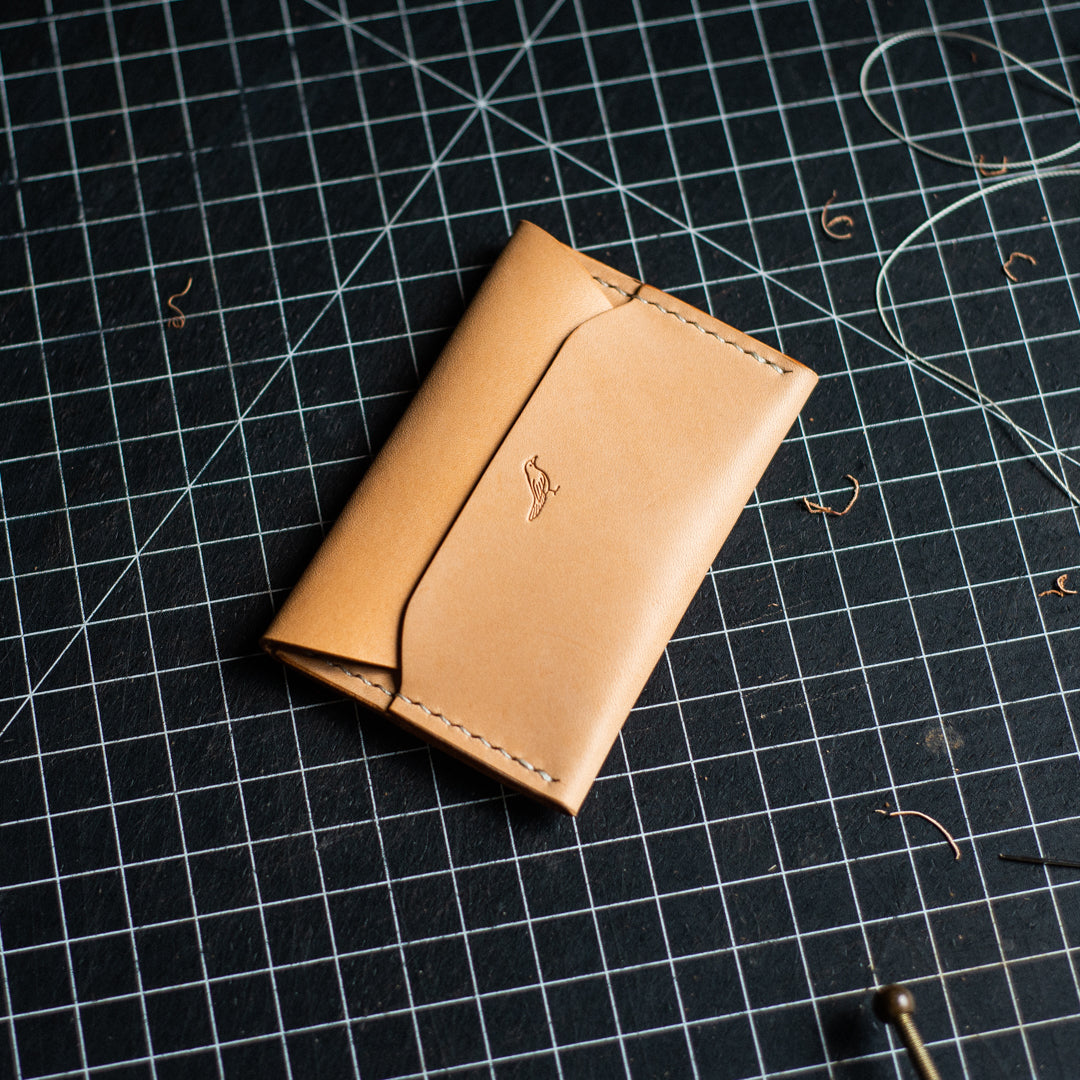 Closed Natural Pattern - Warden Wallet displayed on a workbench.