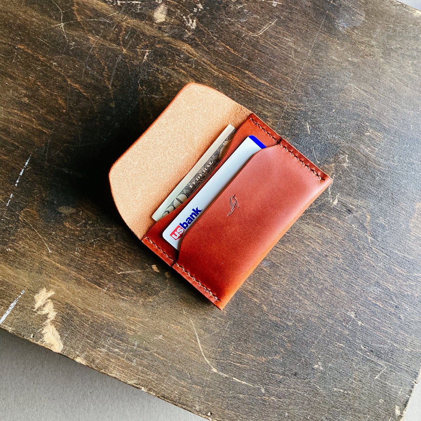 Opened Brown Pattern - Warden Wallet displayed on a brown table.