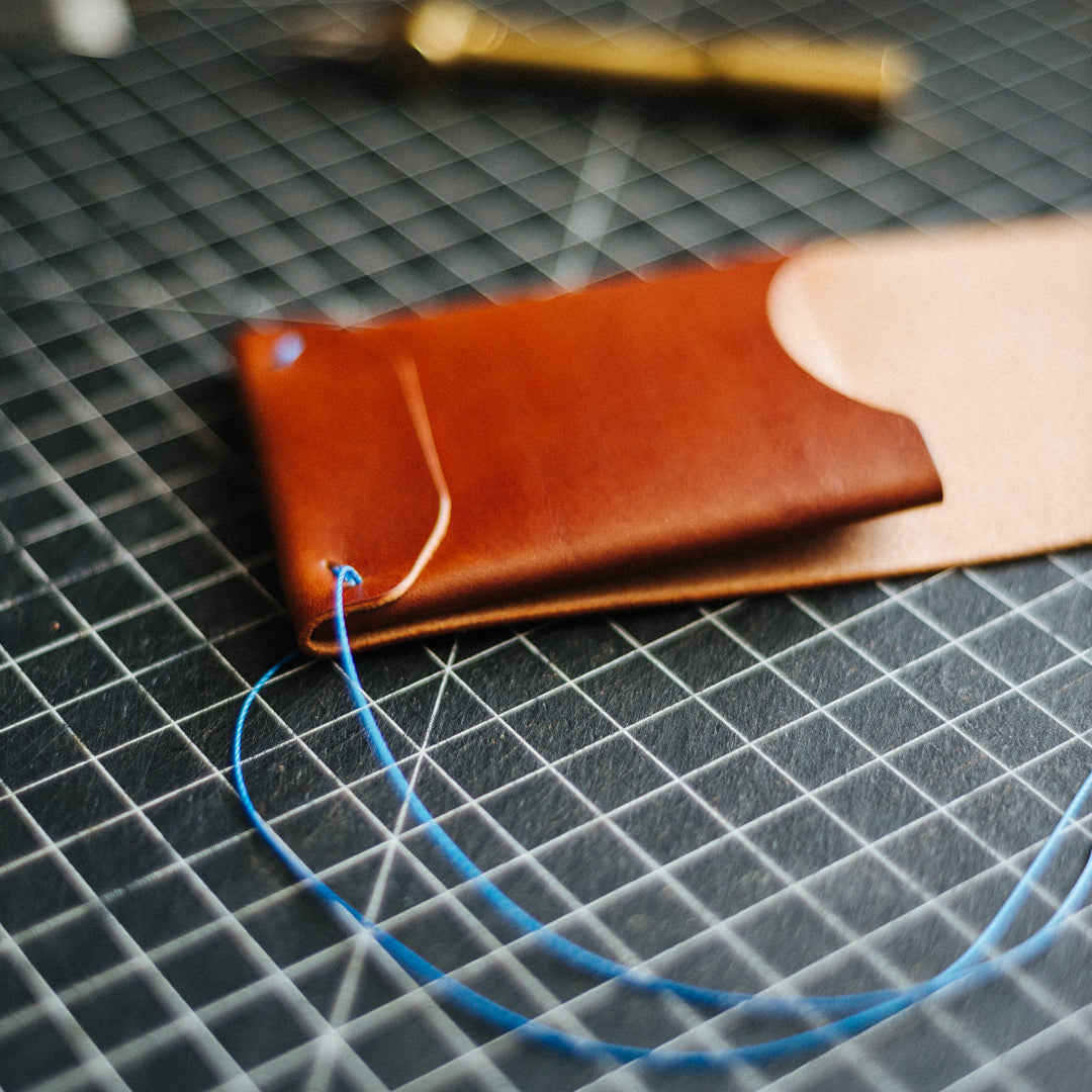 Crafting a brown Archer wallet on a worktable