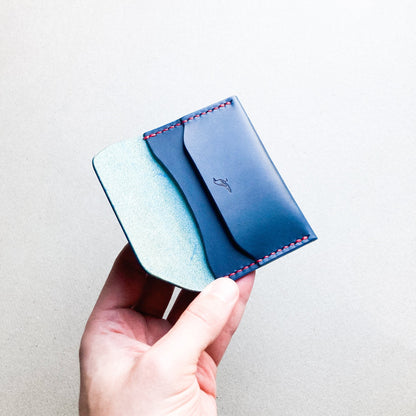 Opened Blue Pattern - Warden Wallet held by a man against a blurred background.