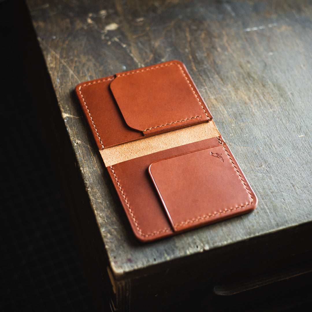 Brown opened Pattern - Garrison Wallet displayed on a brown table.