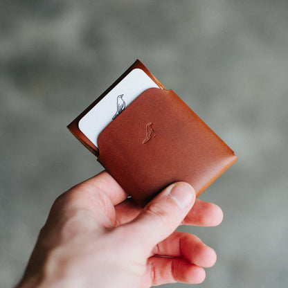 Opened Brown Pattern Emerson Wallet featuring a Harland card neatly displayed inside being held by a man