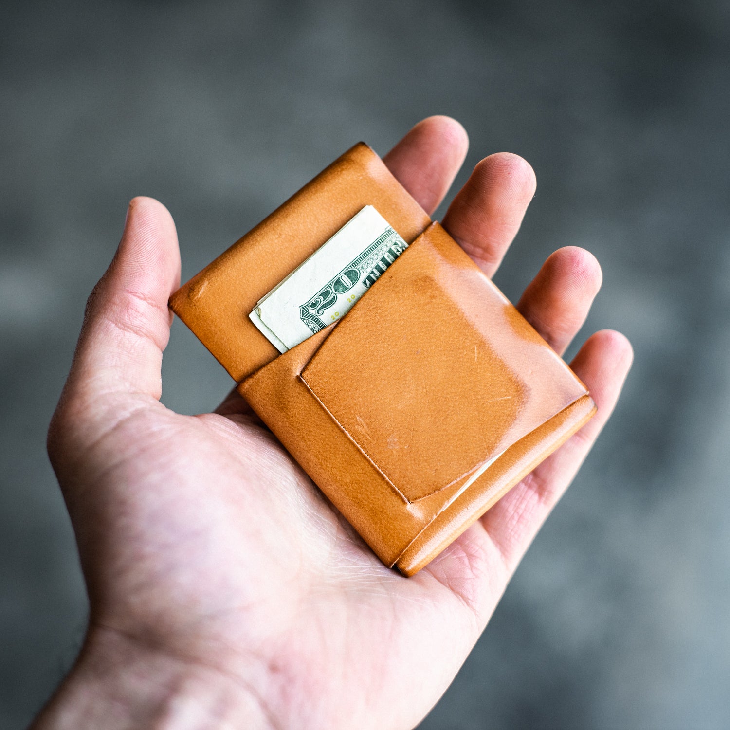 Closed Light Brown Pattern Emerson Wallet featuring a Harland card neatly displayed inside being held by a man