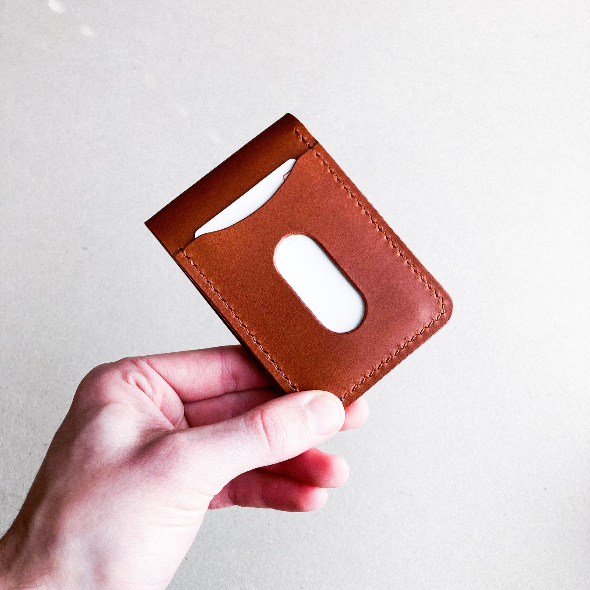 Opened Brown Pattern - Kingston Wallet held by a man against a brown blurred background.